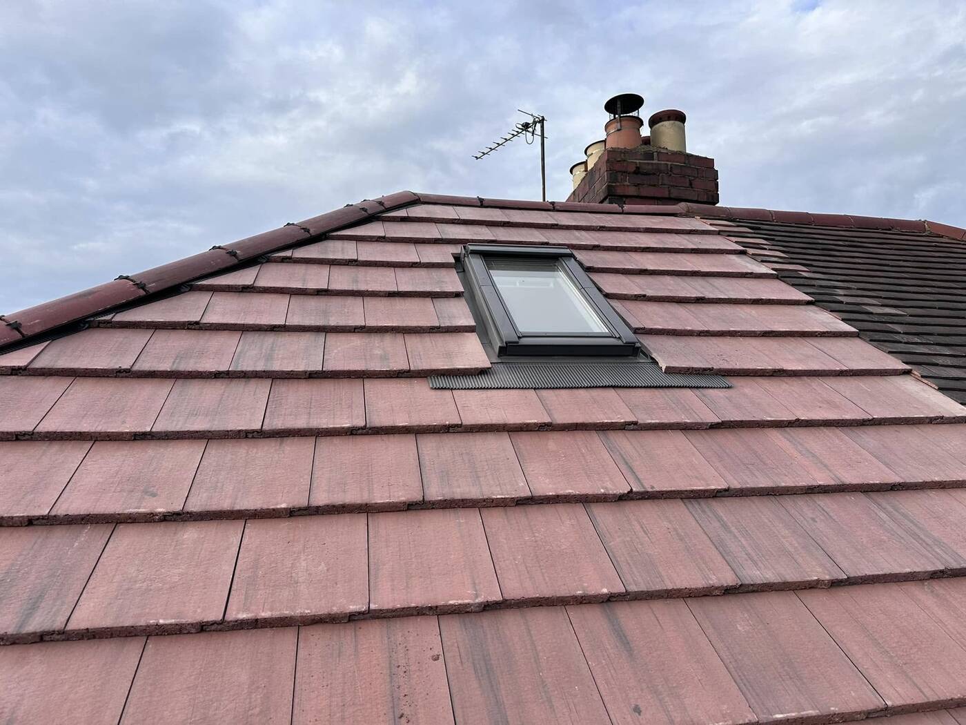 Newly tiled roof with skylight, completed by RD Roofing